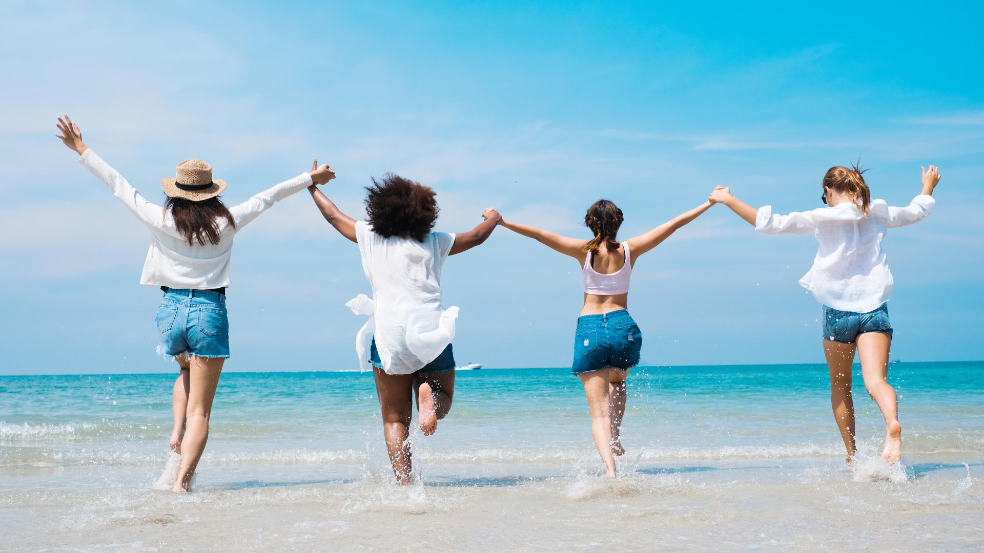 A Group Of Friends Holding Hands And Running Together Toward The Sea