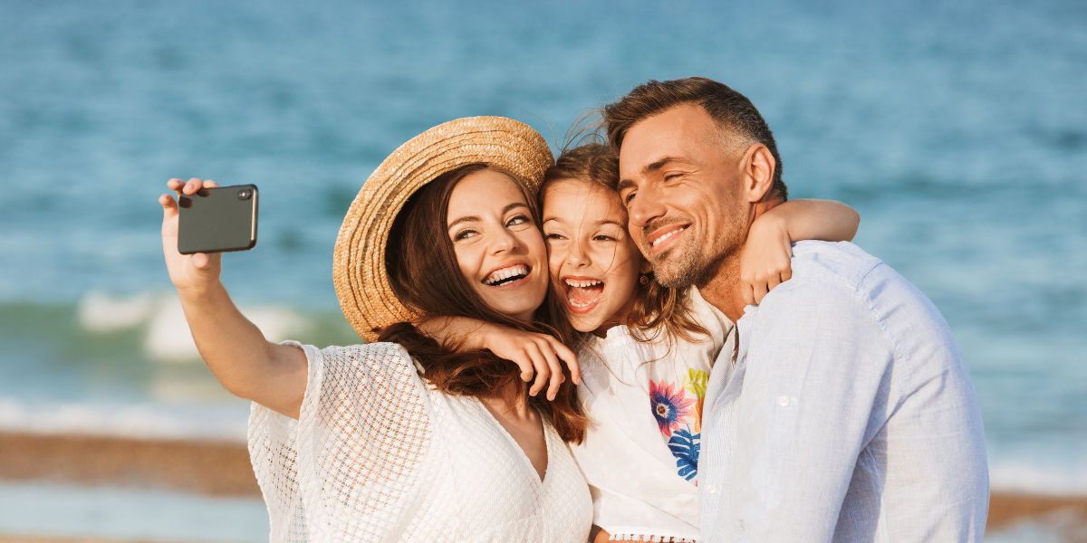 family taking a selfie at the beach happy family on fall vacation at the beach