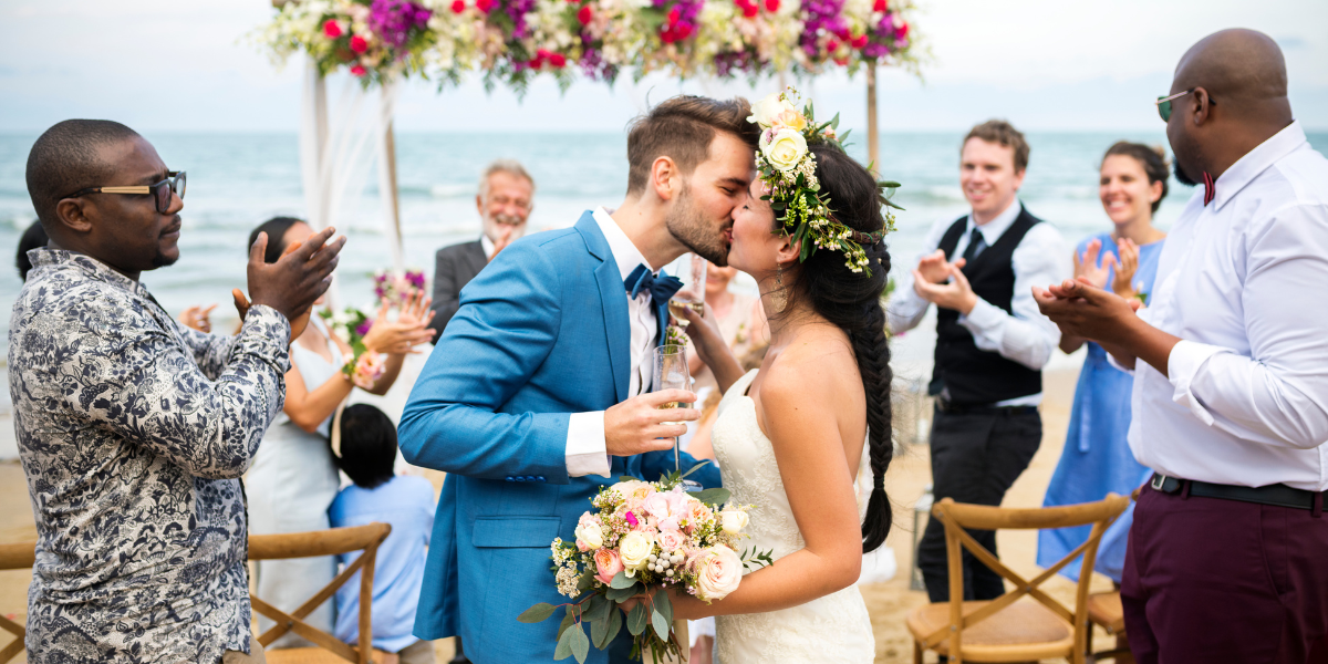 Group of happy people celebrating at a beach wedding