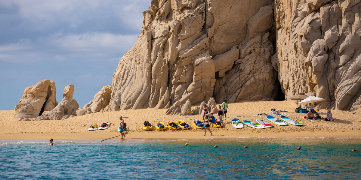 best beach for swimming in Cabo Group of people enjoying a day at the beach