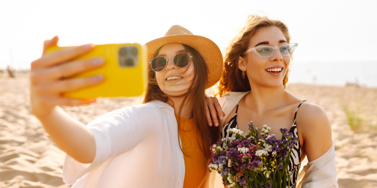 Friends taking a selfie on a day at the beach