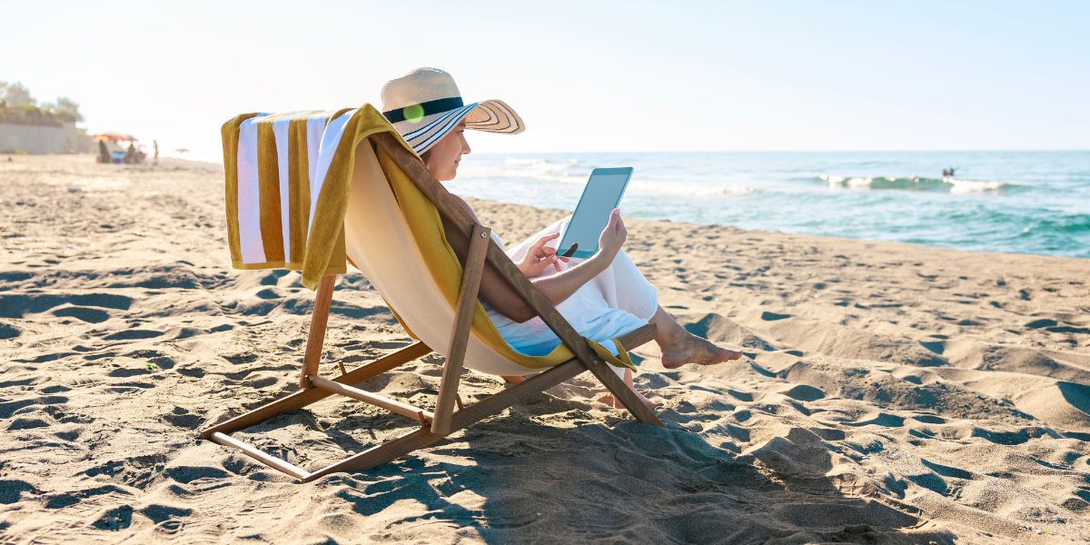 Woman reading in a beach chair overlooking the ocean