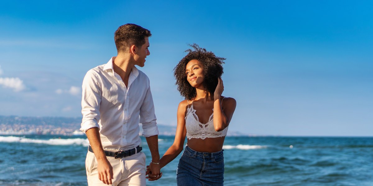 A happy couple strolling along the seashore