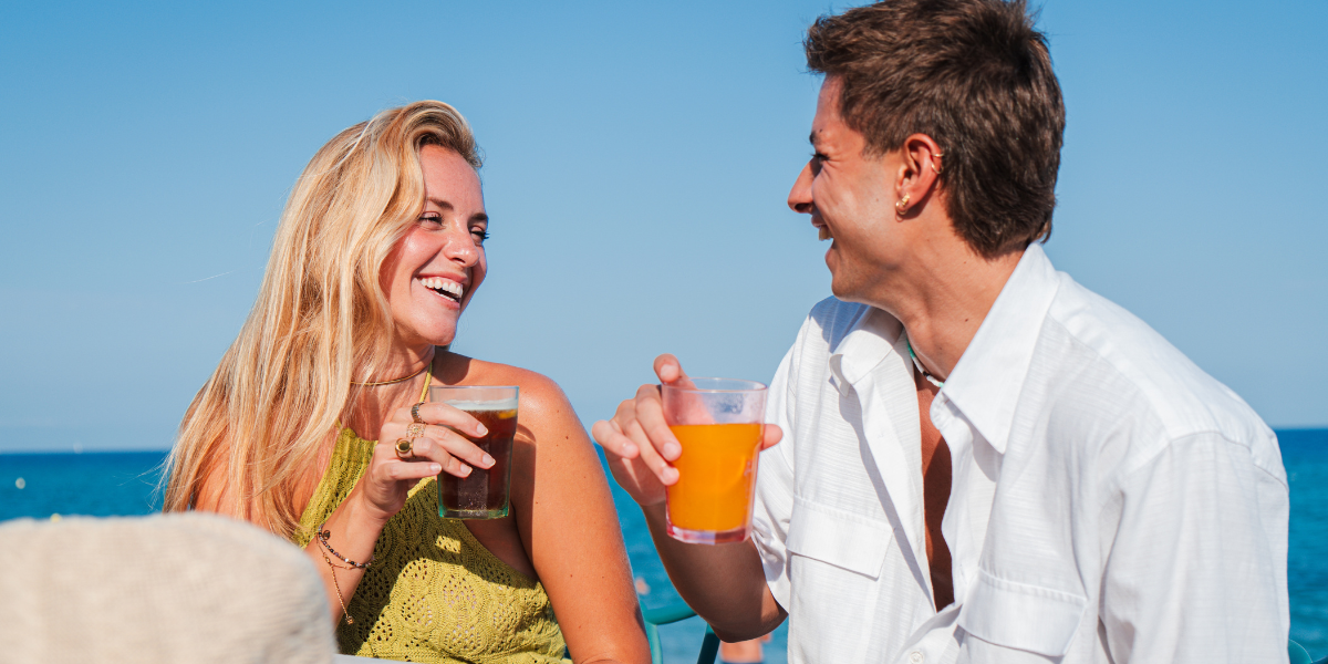 A couple celebrating with a toast on the beach